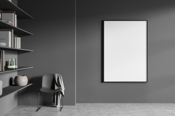 Dark living room interior with empty white poster, armchair, bookshelves