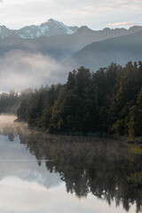 Early and misty morning at lake Matheson New Zealand
