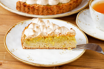 Closeup piece of homemade lemon meringue pie. Shallow focus.
