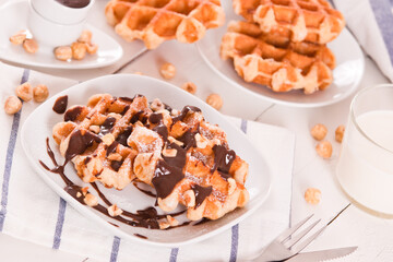 Waffles with chocolate cream and hazelnuts.