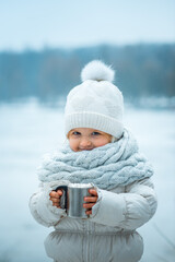 girl holding hot chocolate at the park