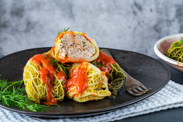 Gołabki - classic Polish dish of cabbage rolls stuffed with pork and rice in tomato sauce