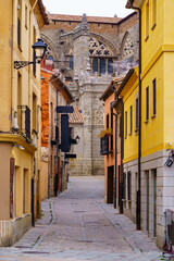 Fototapeta premium Picturesque narrow alley with colorful houses and Avila Cathedral in the background. Spain.