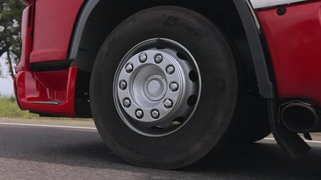 Truck wheels in motion close up. Shooting truck wheels close-up. The truck is moving on the highway