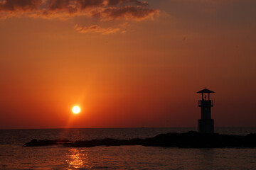 Landscape nature sunset and red  twilight sky with Silhouette  lighthouse on the rock at Nang Thong Beach at Khao Lak Phang Nga Thailand - Seascape chill vibe on the beach - beautiful sky  