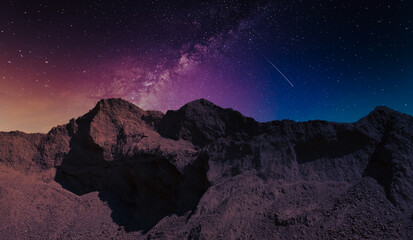 starry night sky in the mountains before sunrise