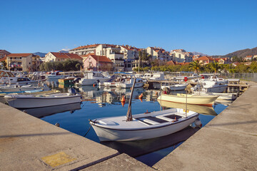 Fototapeta na wymiar Fishing boats in harbor. Montenegro, Tivat city. View of Marina Kalimanj on sunny winter day