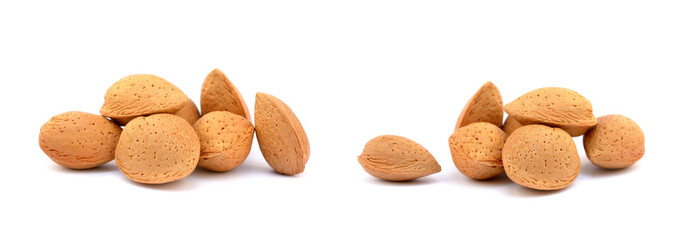 Heap of fresh almonds in shells isolated on white background