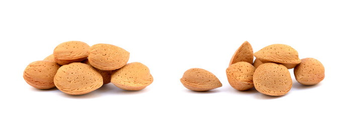 Heap of fresh almonds in shells isolated on white background