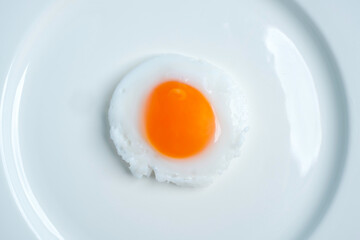 Fried eggs isolated on white background, top view, soft focus.