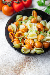 pasta conchiglie colorful mix Italian food durum wheat semolina flour semola healthy meal food snack on the table copy space food background rustic top view