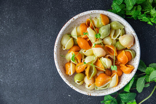 pasta conchiglie colorful mix Italian food durum wheat semolina flour semola healthy meal food snack on the table copy space food background rustic top view