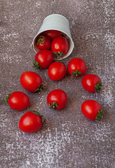 Red ripe tomatoes on dark grey cement background