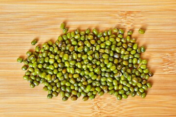mung beans on bamboo board background, top view