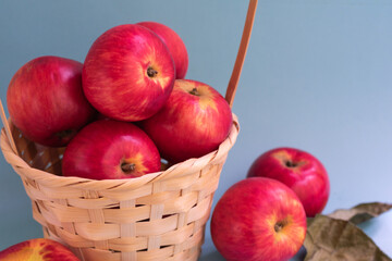 Group of ripe raw red apples on blue background, close up view.