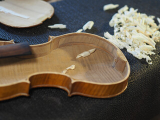 luthier artisan restoring an old italian classic handmade violin in his workshop - specialized...