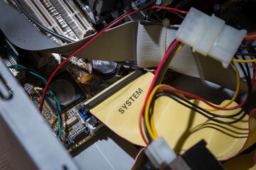 Old computer inside. Printed circuit boards, wires, connectors, microchips inside the system unit.