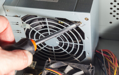 Hardware installation and repair of the computer system unit with help of screwdriver.