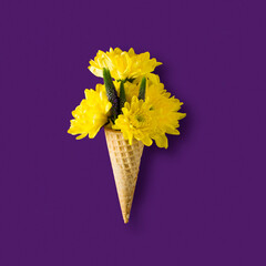 ice cream cone with yellow chrysanthemums on a purple background