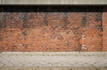 Red old brick wall and sidewalk as background image