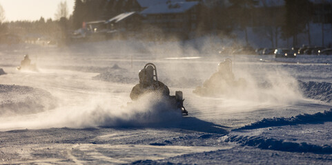 Ice karting action on sunny winter day. Motorsports racing activity in Finland. - obrazy, fototapety, plakaty