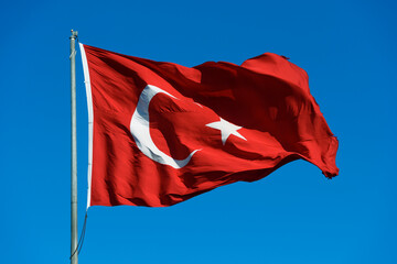 Naklejka na ściany i meble Turkish flag waving on the blue sky.