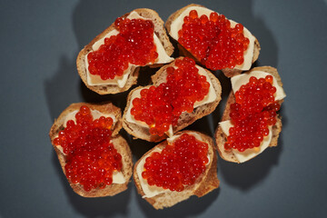Obraz na płótnie Canvas sandwiches with red caviar on white bread with butter