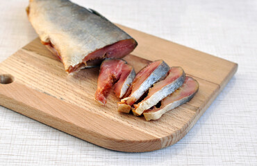 Salty fish. Pieces of salted salmon on a wooden cutting board