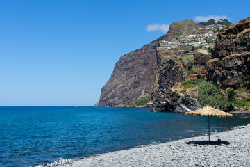 Fototapeta premium Câmara de Lobos beach with beachumbrella, Madeira island