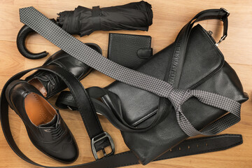 Male classic accessories. Beautiful black classic men's accessories, leather briefcase, belt, tie and shoes. Top view - 482155279