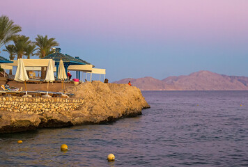 Sunset at luxury tropical resort on Red Sea coast in Sharm el Sheikh, popular resort in Egypt,...