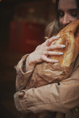 girl walks around the city French baguette in her hands