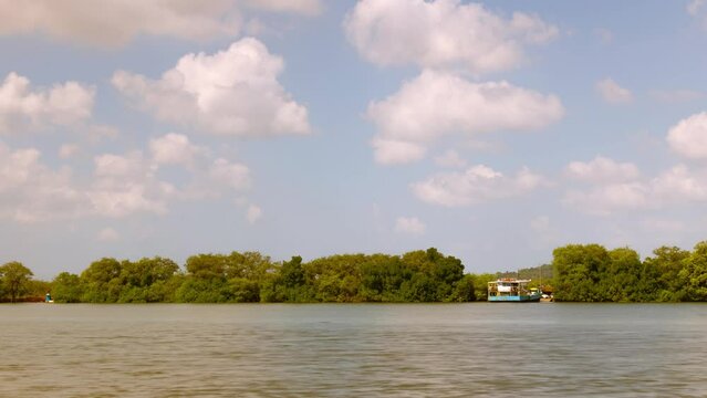 4K Timelapse footage of Ferry boat rides from Old Goa to Borim island in Goa India . Ferry boats time lapse footage. Maritime activities on a sunny day with clouds moving in the sky.