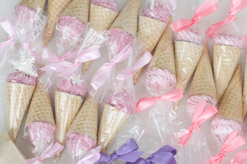 Pink marshmallow in waffle cones. Packed in sachets. Close-up.