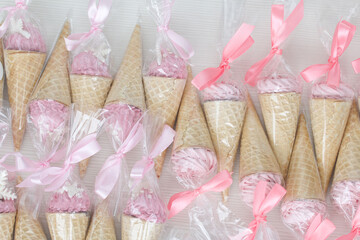 Pink marshmallow in waffle cones. Packed in sachets. Close-up.