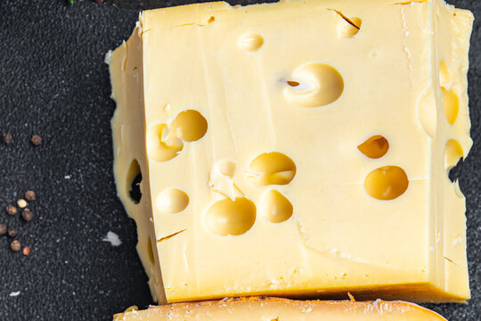 cheese holes hard aged maasdam, radamer, masdamer fresh dietary healthy meal food diet snack on the table copy space food background rustic top view