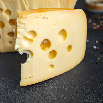 cheese holes hard aged maasdam, radamer, masdamer fresh dietary healthy meal food diet snack on the table copy space food background rustic top view