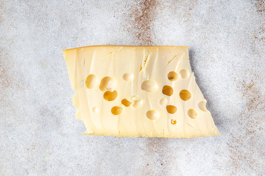 cheese holes hard aged maasdam, radamer, masdamer fresh dietary healthy meal food diet snack on the table copy space food background rustic top view