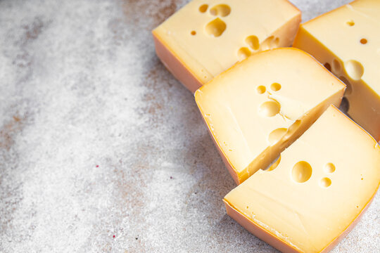 cheese holes hard aged maasdam, radamer, masdamer fresh dietary healthy meal food diet snack on the table copy space food background rustic top view