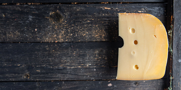 cheese holes hard aged maasdam, radamer, masdamer fresh dietary healthy meal food diet snack on the table copy space food background rustic top view