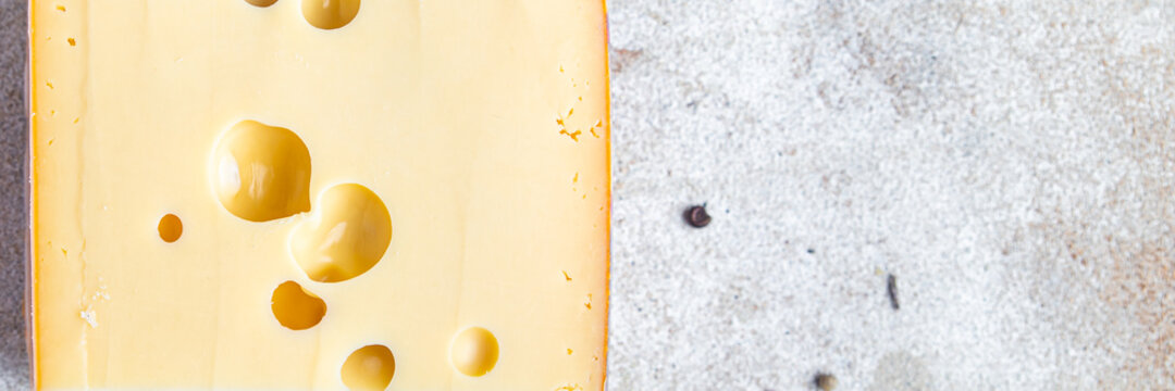 cheese holes hard aged maasdam, radamer, masdamer fresh dietary healthy meal food diet snack on the table copy space food background rustic top view