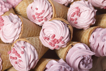 Zephyr in waffle cones. Decorated with decorative sprinkles and mastic snowflakes. Close-up.