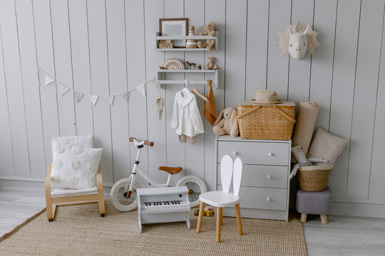 Scandinavian style children's room interior with toys White bicycle and small piano for learning