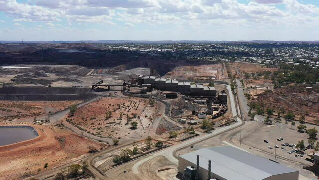 Mining plant buildings and warehouses in aerial flying over mine site 4k.
