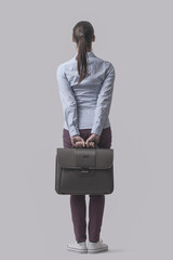 Businesswoman holding her briefcase back view
