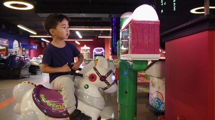 Preschooler playing on amusement park and slot machines