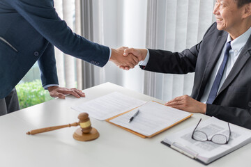 law concept The solicitor and the businessman shaking their hands firmly for having done their job...