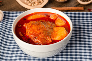 Chicken Massaman Curry on white bowl. Muslim curry or mussaman curry. Muslim style chicken and potato or chicken mussaman curry.