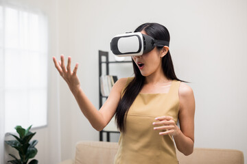 Young asian woman put on vr glasses into virtual simulated world. Future technology digital cyber...