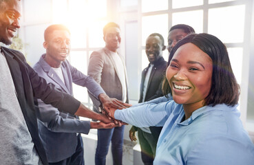 young business woman and her colleagues are showing their unity .